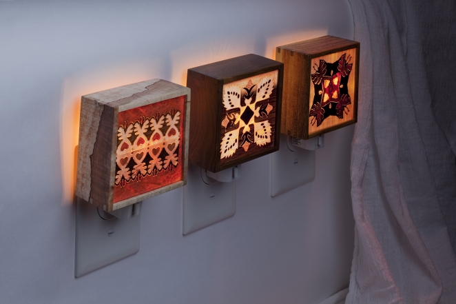 Marquetry nightlights displayed lit.